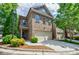 Charming brick two-story home with a two-car garage and landscaped front yard at 2227 W Village Se Ln, Smyrna, GA 30080