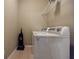 Efficient laundry room setup featuring a washer, dryer, vacuum cleaner and wire shelving for convenient storage and organization at 2227 W Village Se Ln, Smyrna, GA 30080
