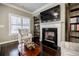 Elegant living room with a fireplace, built-in bookshelves, and comfortable seating at 2227 W Village Se Ln, Smyrna, GA 30080