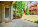 Inviting patio area with access to the building's landscaped outdoor space and wood staircase leading to the upper level decks at 2227 W Village Se Ln, Smyrna, GA 30080