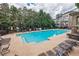 Community pool area surrounded by lounge chairs and lush landscaping, perfect for relaxation and recreation at 2227 W Village Se Ln, Smyrna, GA 30080