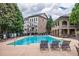 Exterior view of a sparkling community pool with plenty of seating and lush landscaping providing an inviting atmosphere at 2227 W Village Se Ln, Smyrna, GA 30080