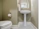 Cozy half bathroom featuring a pedestal sink and modern fixtures at 2227 W Village Se Ln, Smyrna, GA 30080