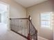 Carpeted staircase featuring rod iron spindles and wood trim at 2227 W Village Se Ln, Smyrna, GA 30080