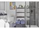 Stylish bathroom featuring dark tiling, open shelving, and sleek, modern fixtures and decor at 3120 Godby Rd, Atlanta, GA 30349