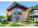 Modern two-story home with a gray exterior, wood accents, large windows, and well-manicured landscaping at 3120 Godby Rd, Atlanta, GA 30349
