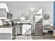 Bright kitchen with white cabinets, stainless appliances, granite countertops, and modern fixtures at 3120 Godby Rd, Atlanta, GA 30349