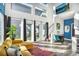 Open-concept space featuring a living area, stairs, and a glimpse of a modern kitchen with natural lighting at 3120 Godby Rd, Atlanta, GA 30349