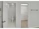 Bathroom with tile floors showcasing the toilet and a walk-in closet with wire shelving at 1411 Blackland Trl, Lawrenceville, GA 30043