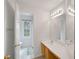 Bathroom with bright lights and single vanity showcasing tile floors and toilet at 1411 Blackland Trl, Lawrenceville, GA 30043