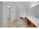 Bathroom featuring double sinks, a tiled floor, a soaking tub, and a glass walk-in shower at 1411 Blackland Trl, Lawrenceville, GA 30043
