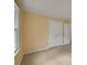 A cozy bedroom features neutral walls and carpet, complemented by natural light and double door closet at 1411 Blackland Trl, Lawrenceville, GA 30043