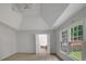 Bright bedroom with a ceiling fan, neutral carpet, and large windows overlooking a fenced-in backyard at 1411 Blackland Trl, Lawrenceville, GA 30043