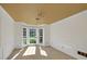 Sunlit dining room with a bay window, neutral carpet, crown molding, and classic wainscoting at 1411 Blackland Trl, Lawrenceville, GA 30043