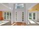 Inviting foyer with wood floors, natural light, white trim, and views into the living and dining room at 1411 Blackland Trl, Lawrenceville, GA 30043