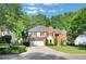 Charming two-story brick home with manicured lawn and a two-car garage at 1411 Blackland Trl, Lawrenceville, GA 30043