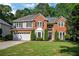 Charming two-story brick home with manicured lawn and a two-car garage at 1411 Blackland Trl, Lawrenceville, GA 30043