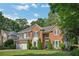 Charming two-story brick home with manicured lawn and a two-car garage at 1411 Blackland Trl, Lawrenceville, GA 30043