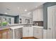 Contemporary kitchen with white cabinets, quartz countertops, stainless steel appliances, and a subway tile backsplash at 1411 Blackland Trl, Lawrenceville, GA 30043