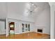 Bright and airy living room with fireplace, vaulted ceiling, and french doors to sunroom at 1411 Blackland Trl, Lawrenceville, GA 30043