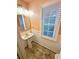 Stylish half bathroom with pedestal sink, modern lighting and sleek mirror at 1411 Blackland Trl, Lawrenceville, GA 30043