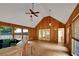 Vaulted sunroom with a jacuzzi, wood paneling, and tile floors at 1411 Blackland Trl, Lawrenceville, GA 30043