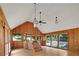 Relaxing sunroom featuring a hot tub, wood paneling and views of the backyard at 1411 Blackland Trl, Lawrenceville, GA 30043
