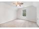 Vaulted bedroom featuring carpeted floors, a ceiling fan, and a bright window at 1595 Cedar Hl, Douglasville, GA 30134