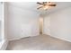 Bright bedroom features a ceiling fan, neutral carpet, closet and storage space at 1595 Cedar Hl, Douglasville, GA 30134