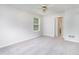 Bedroom with neutral walls and carpet, a ceiling fan, and a view to the exterior at 1595 Cedar Hl, Douglasville, GA 30134