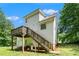 Rear exterior of a two-story home with a deck and stairs at 1595 Cedar Hl, Douglasville, GA 30134
