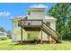 Rear exterior view of the home with a deck and stairs at 1595 Cedar Hl, Douglasville, GA 30134