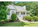 Quaint home with a manicured lawn, covered porch, and charming curb appeal at 1595 Cedar Hl, Douglasville, GA 30134