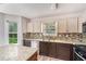Well-lit kitchen featuring granite countertops, mosaic backsplash, and stainless steel appliances at 1595 Cedar Hl, Douglasville, GA 30134