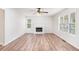 Bright living room featuring a fireplace, hardwood floors, and large windows at 1595 Cedar Hl, Douglasville, GA 30134