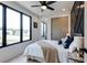 Bright bedroom features a ceiling fan, decorative wall, large windows, and hardwood floors at 1968 8Th St, Chamblee, GA 30341