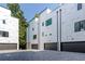 Modern townhomes with gray brick driveways and black garage doors at 1968 8Th St, Chamblee, GA 30341