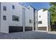 Modern townhomes with gray brick driveways and black garage doors at 1968 8Th St, Chamblee, GA 30341