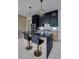 Contemporary kitchen featuring a waterfall island, black cabinets, stainless steel appliances and geometric pendant lighting at 1968 8Th St, Chamblee, GA 30341