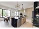 Open concept kitchen featuring a large island, stainless appliances, modern fixtures and adjacent dining area at 1968 8Th St, Chamblee, GA 30341