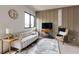 Cozy living room featuring a plush sofa, stylish decor, and a modern wall paneling at 1968 8Th St, Chamblee, GA 30341