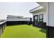 Rooftop terrace features black trim on white siding and bright green turf at 1968 8Th St, Chamblee, GA 30341