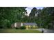 Brick single-story home with manicured lawn, bushes, and a private driveway surrounded by mature trees at 3250 Valley Bend Rd, South Fulton, GA 30349