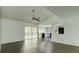 Open-concept living room with hardwood floors, a ceiling fan, and an opening into the kitchen at 3250 Valley Bend Rd, South Fulton, GA 30349