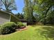 Expansive backyard featuring green grass, mature trees, and a wood privacy fence at 3594 Broxton Ln, Snellville, GA 30039