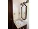 Bathroom featuring white vanity, a decorative mirror, and a dark wooden door at 3594 Broxton Ln, Snellville, GA 30039