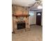 Close-up on the stone fireplace, complete with a wooden mantel and metal screen at 3594 Broxton Ln, Snellville, GA 30039