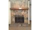 Detailed view of the stone fireplace, enhanced with a wooden mantel and rustic charm at 3594 Broxton Ln, Snellville, GA 30039