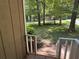 View from the porch onto the home's spacious front yard with mature trees and distant structure at 3594 Broxton Ln, Snellville, GA 30039