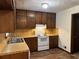 Traditional kitchen featuring wood cabinetry, wood countertops, and white appliances at 3594 Broxton Ln, Snellville, GA 30039